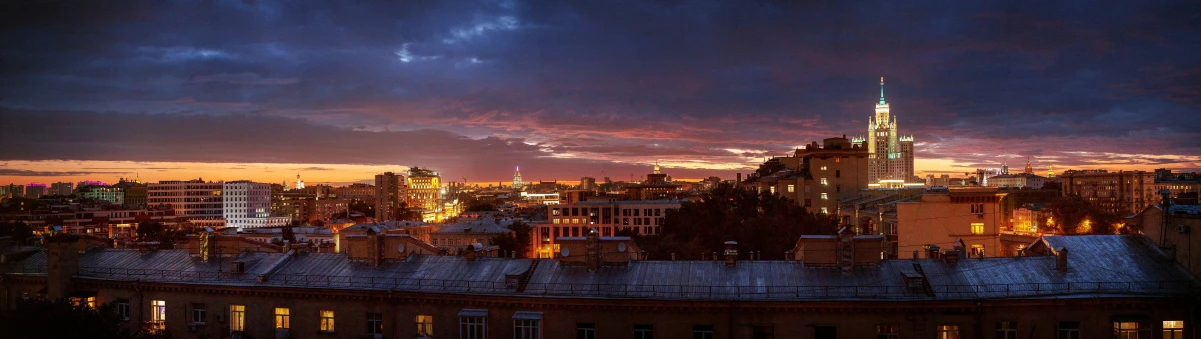 a view of a city at dusk from a rooftop