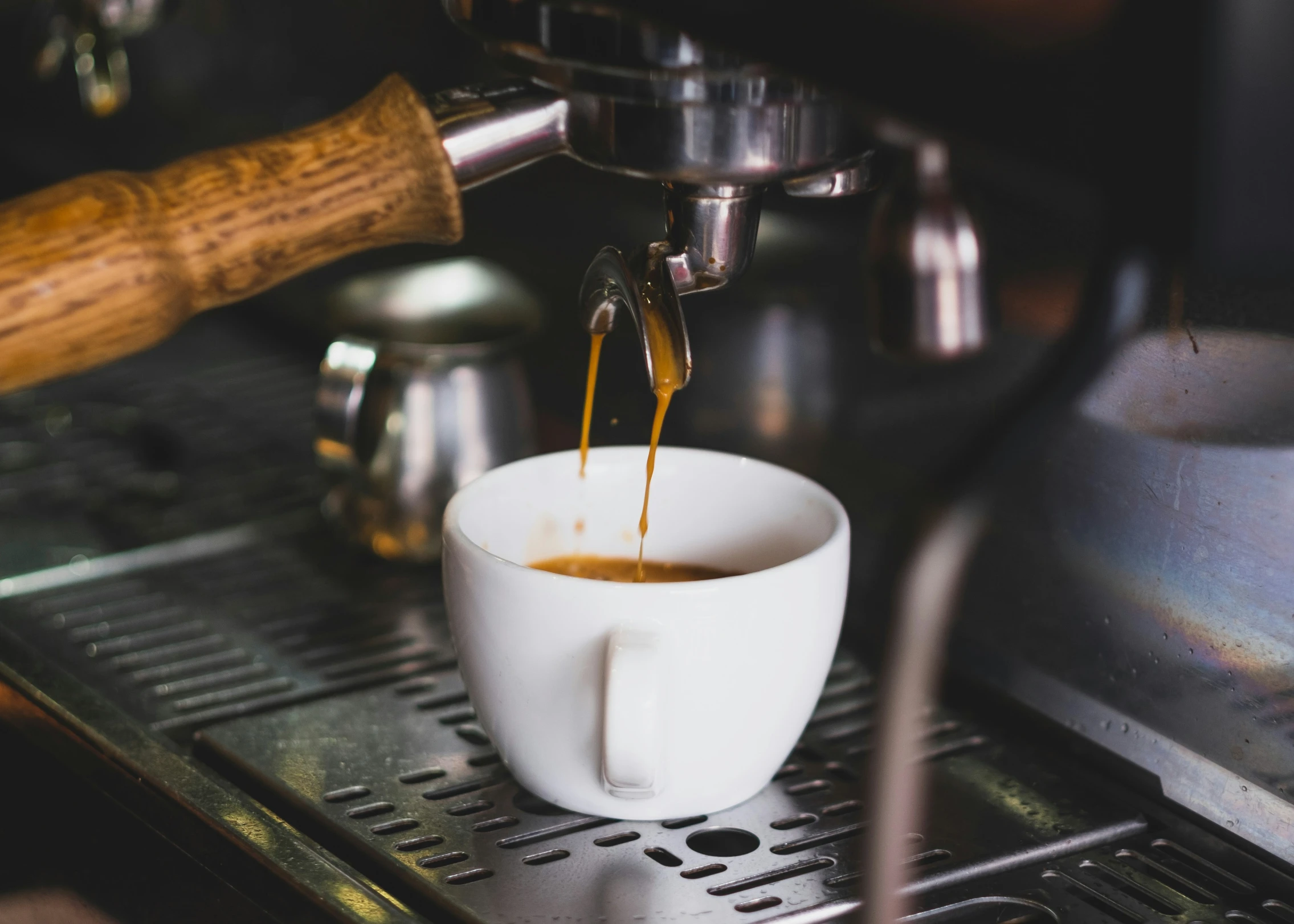 a cup of coffee being filled with liquid