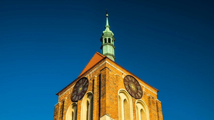 an old church with steeple on clear blue skies