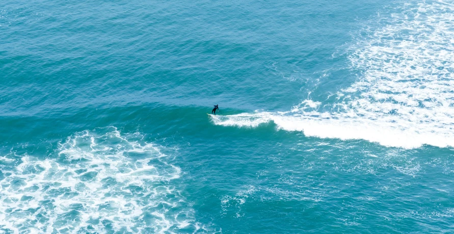 a person is in the water on their surfboard