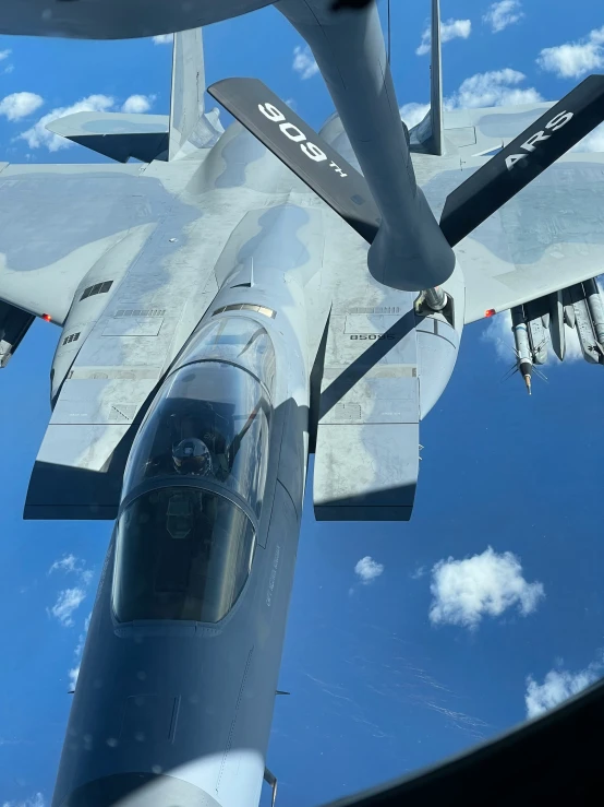 a large grey airplane flies through the sky