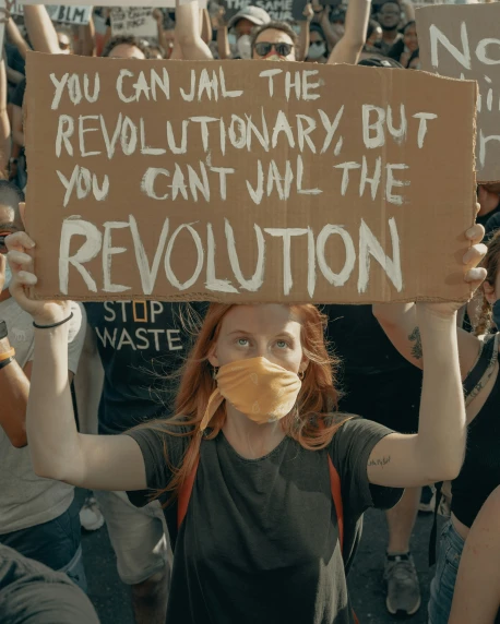 a protest with an ad for the revolution