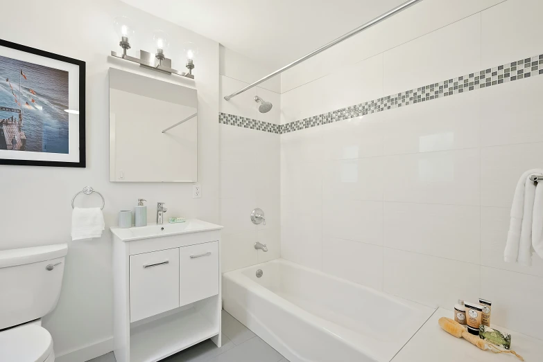 a bathroom has white walls and gray floors