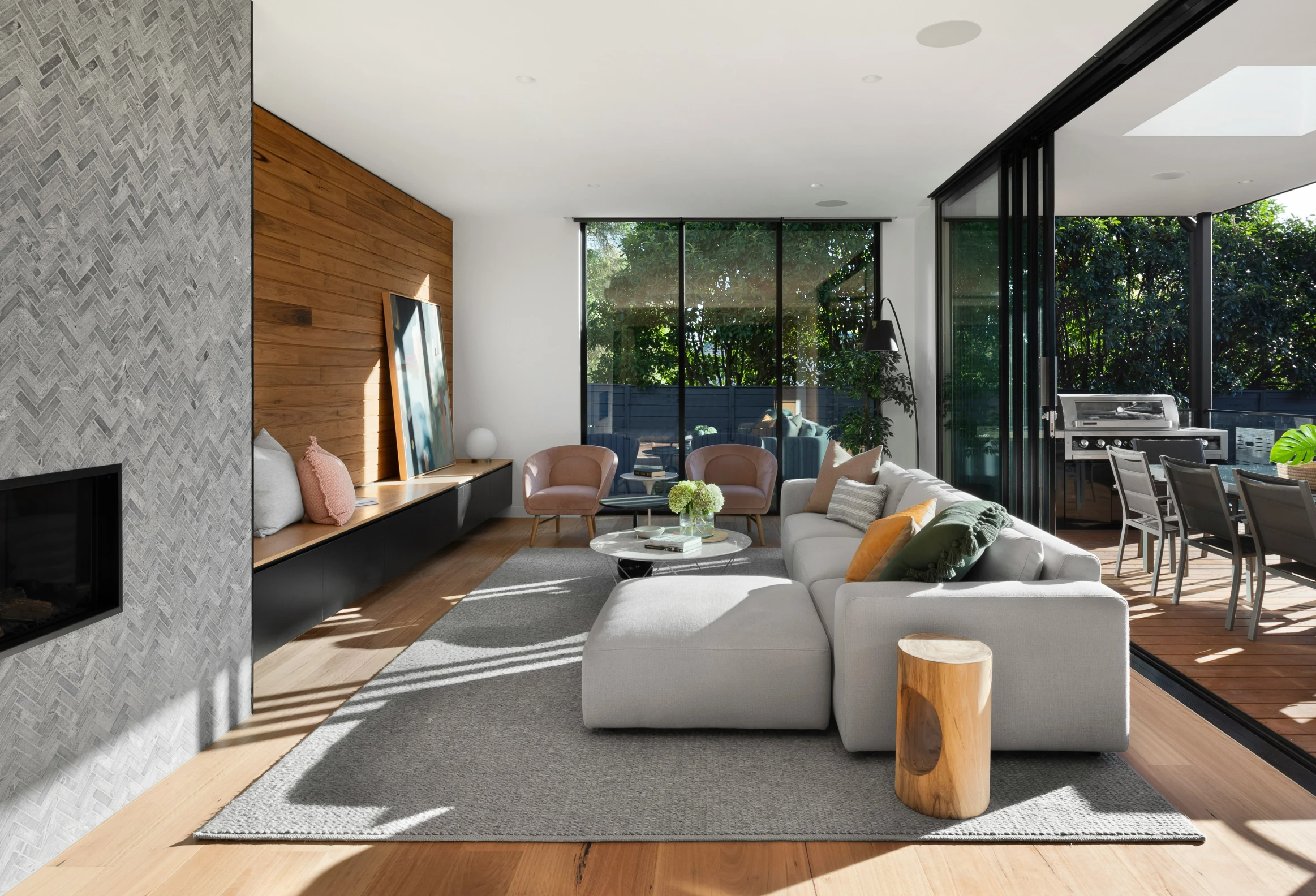 a large open plan living room with glass walls