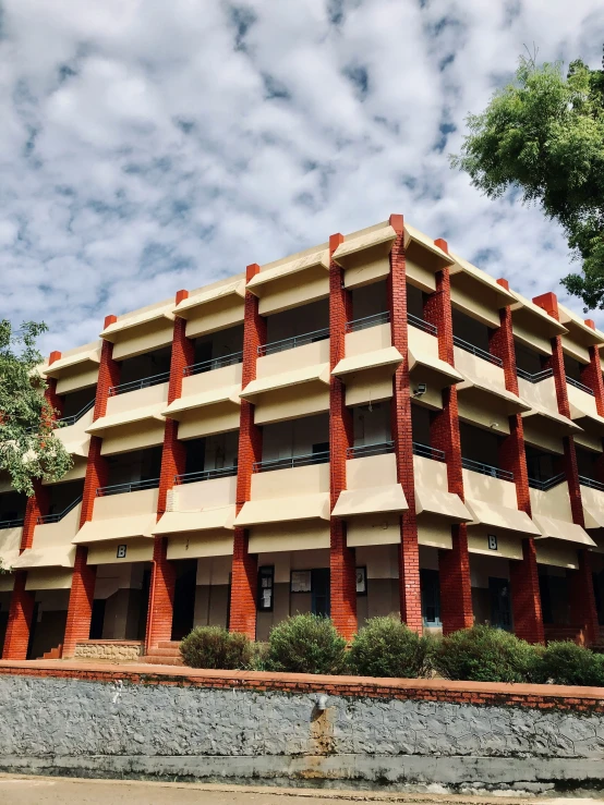 a large building with several stories that is red