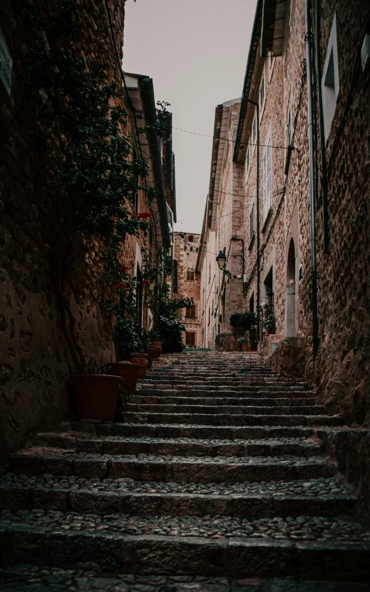 a narrow street is lined with brick buildings