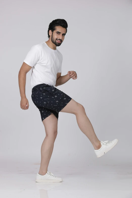 a man poses for a pograph wearing some shorts