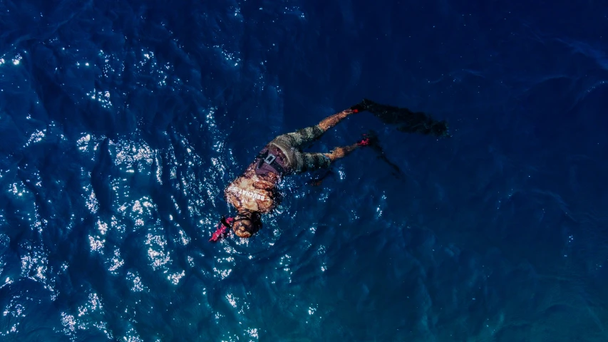 a person floating in the ocean on their back