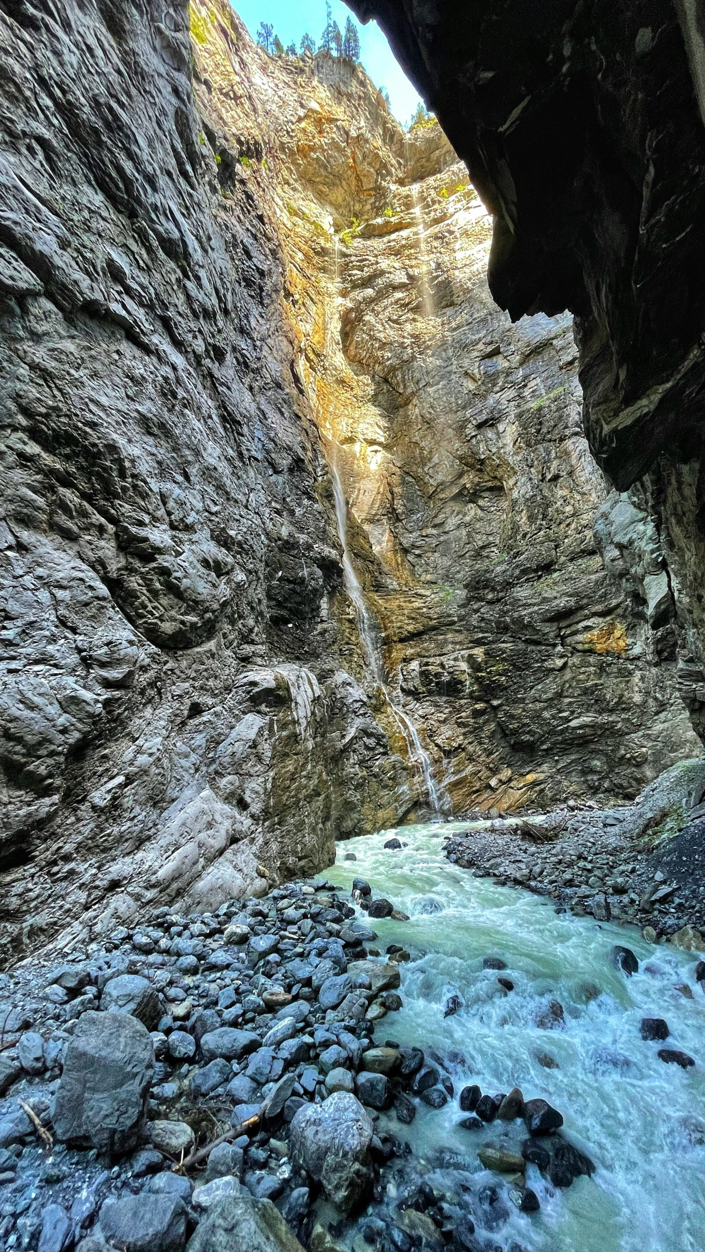 a rocky canyon in the mountains with small streams going through it