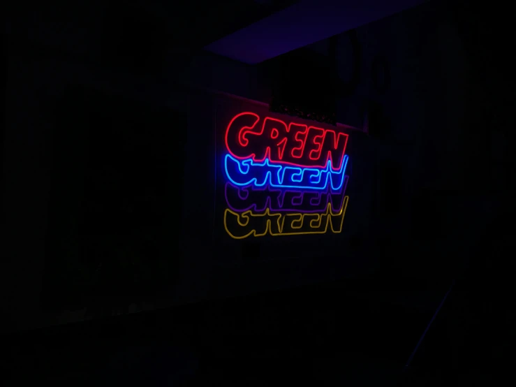 neon sign showing green street and queen neon