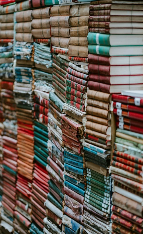 many different books stacked on top of each other