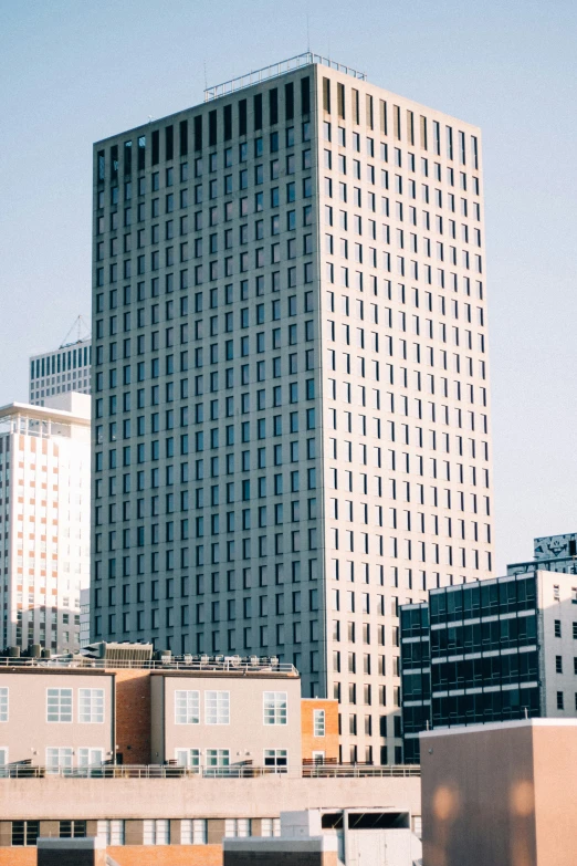 two tall buildings sitting in front of a city skyline