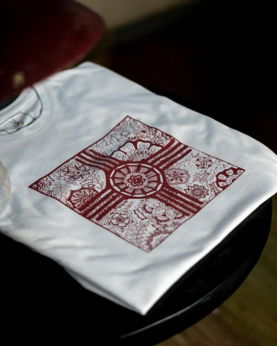 two red pieces of cloth sit on top of a small table