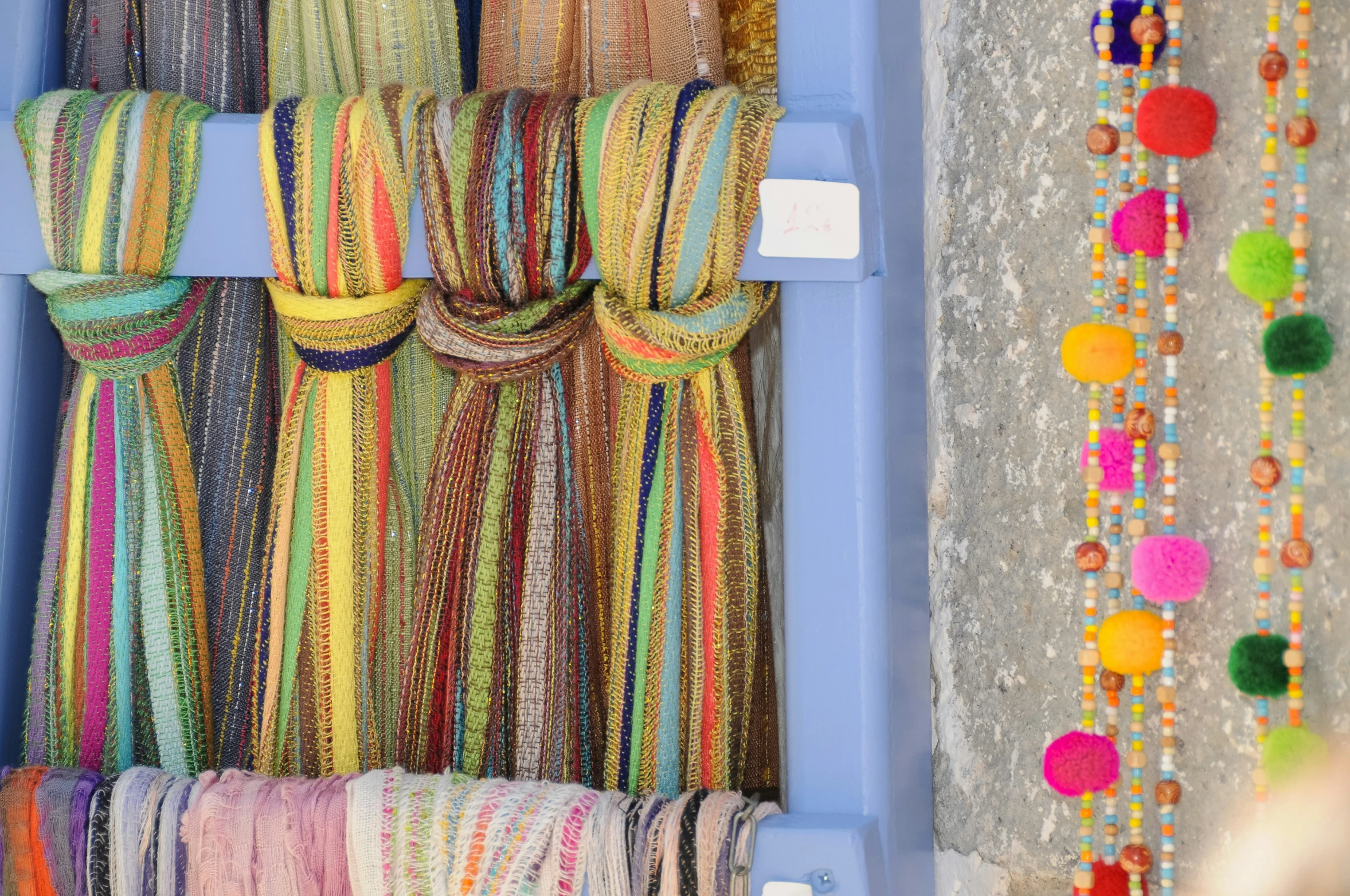 a display case with various colored ties hanging up