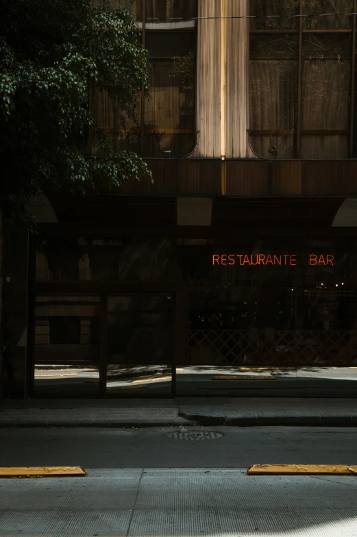 street sign displayed in front of building at night