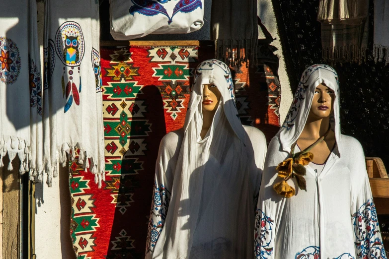 statues of two women stand next to each other in an elaborately decorated setting