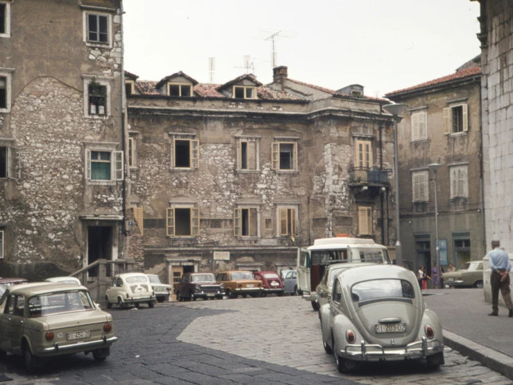 an old building with a street with cars on it