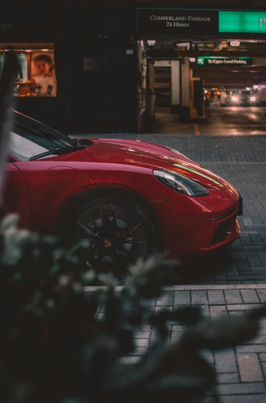 the red sports car parked on the side of a street