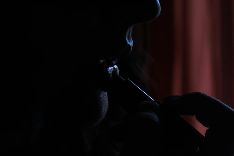 a man in silhouette is seen with a small toothbrush in his mouth