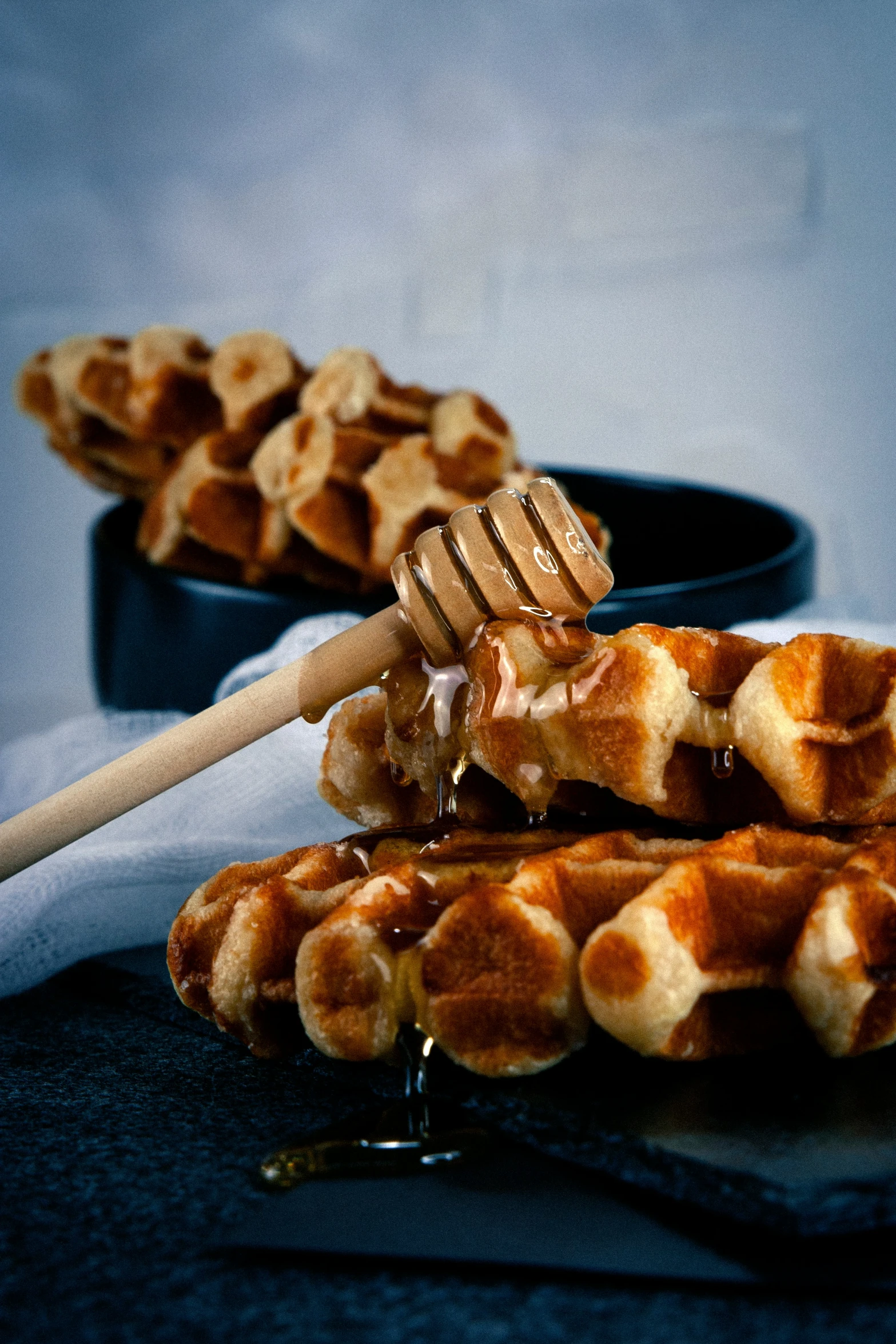 waffles being poured over and drizzled with honey