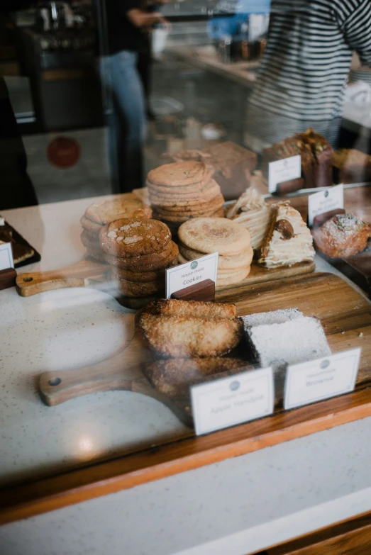 there are many different kinds of pastries behind the glass