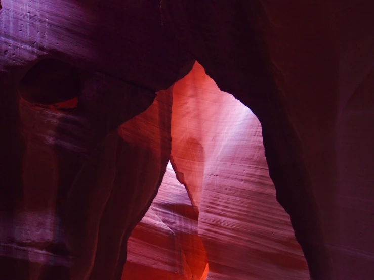 a person is standing in a canyon between some rocks