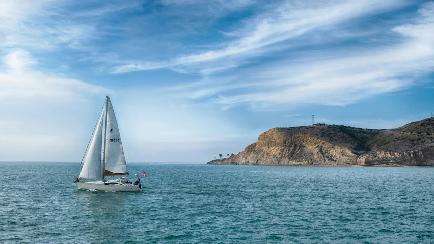 a sailboat in the middle of a body of water