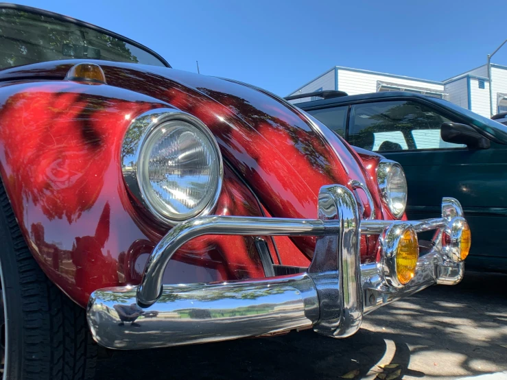 the chrome grilles and headlights of a red vintage car