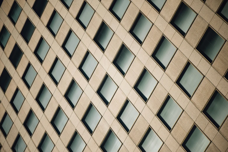 a large window building reflects a very colorful blue sky