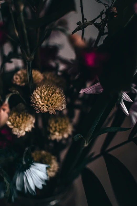 flowers in the center of a vase on the table