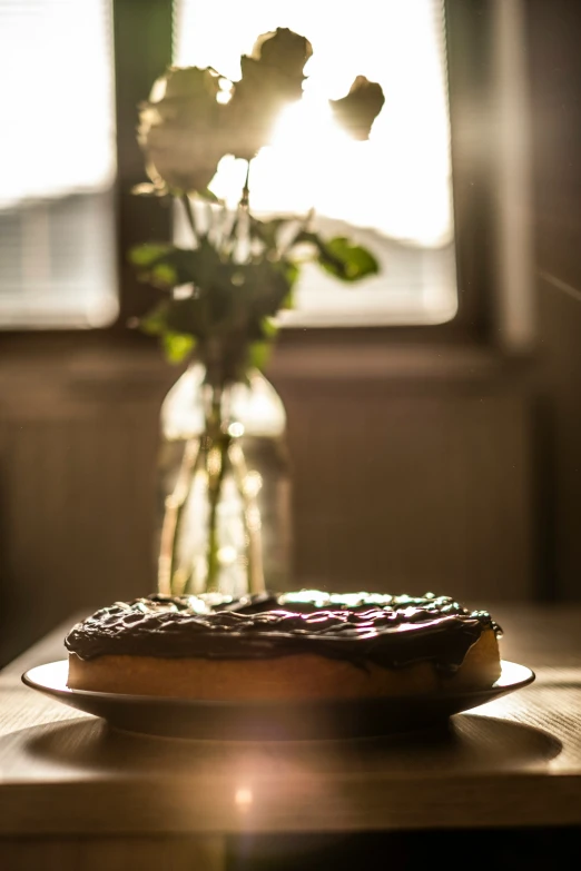 a glass vase with flowers on a wooden table