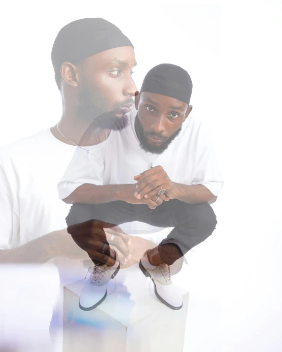 the image shows two men, one with black hair and beards