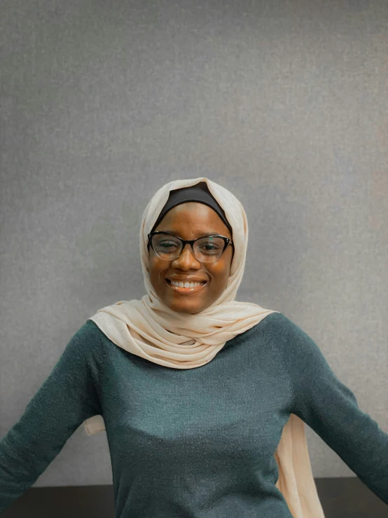 a woman with a headscarf wearing glasses