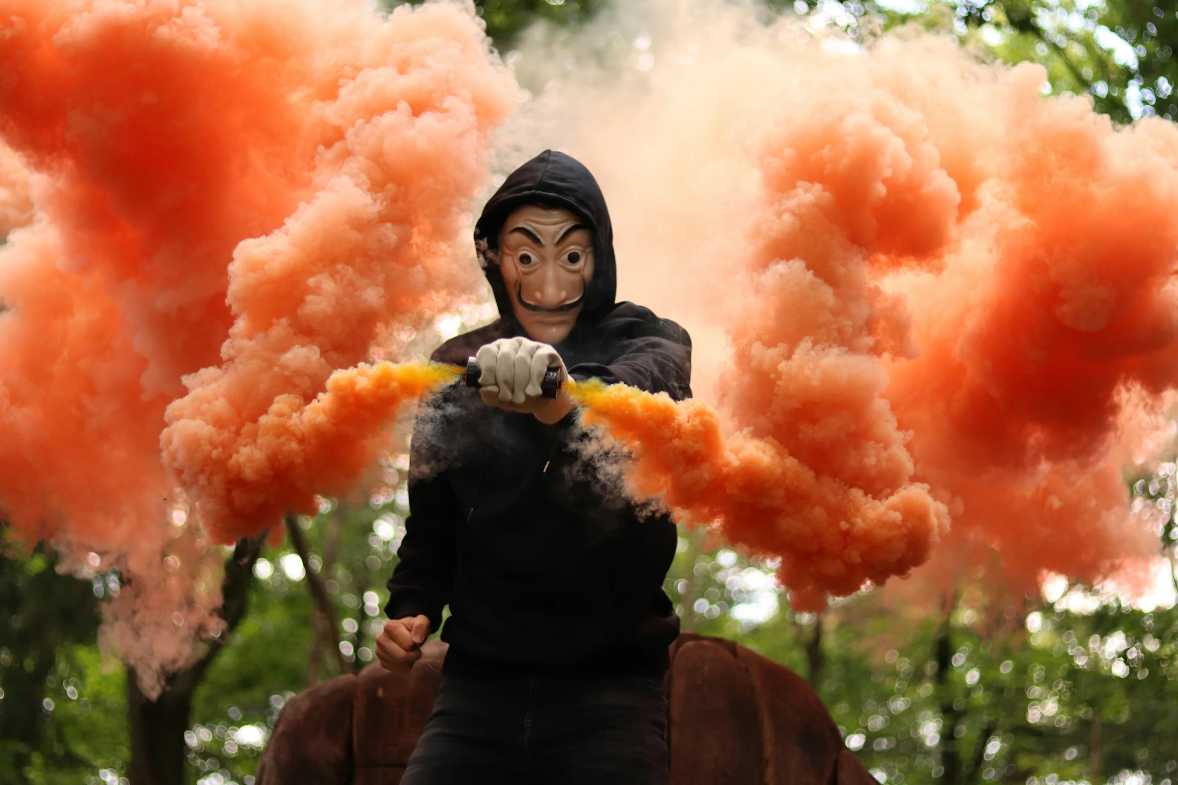 a person wearing a mask riding on top of a horse