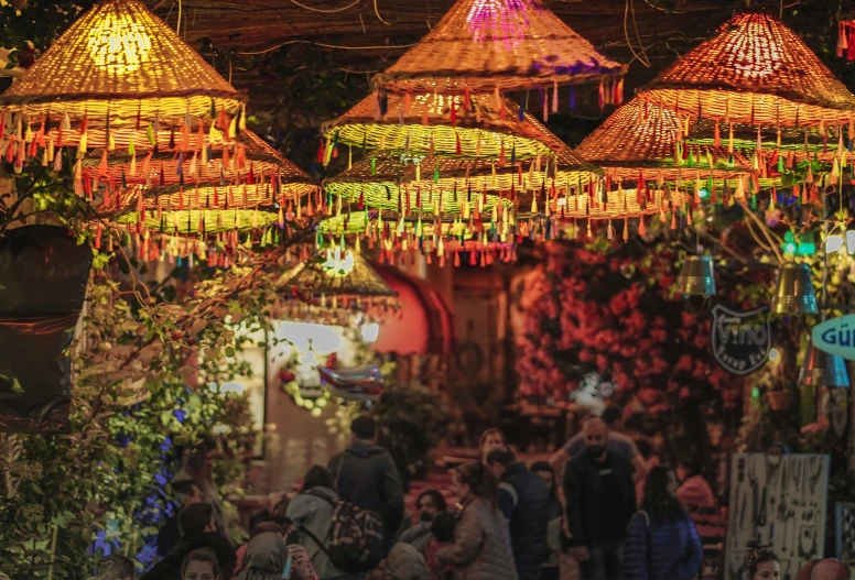 many colorful lights hang from baskets and ceiling lights