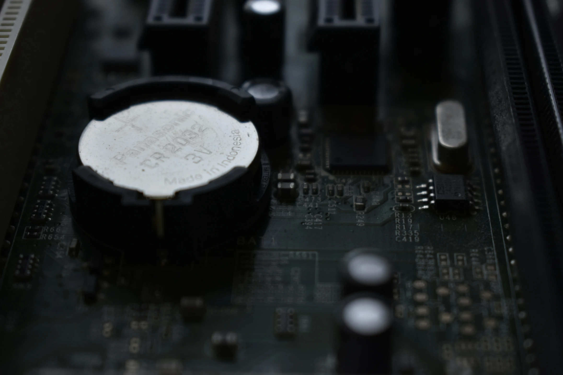 a black and white circuit board with several different screws