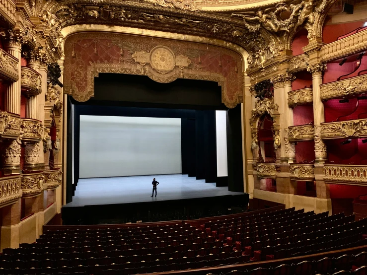an empty theatre with stage curtain in the middle