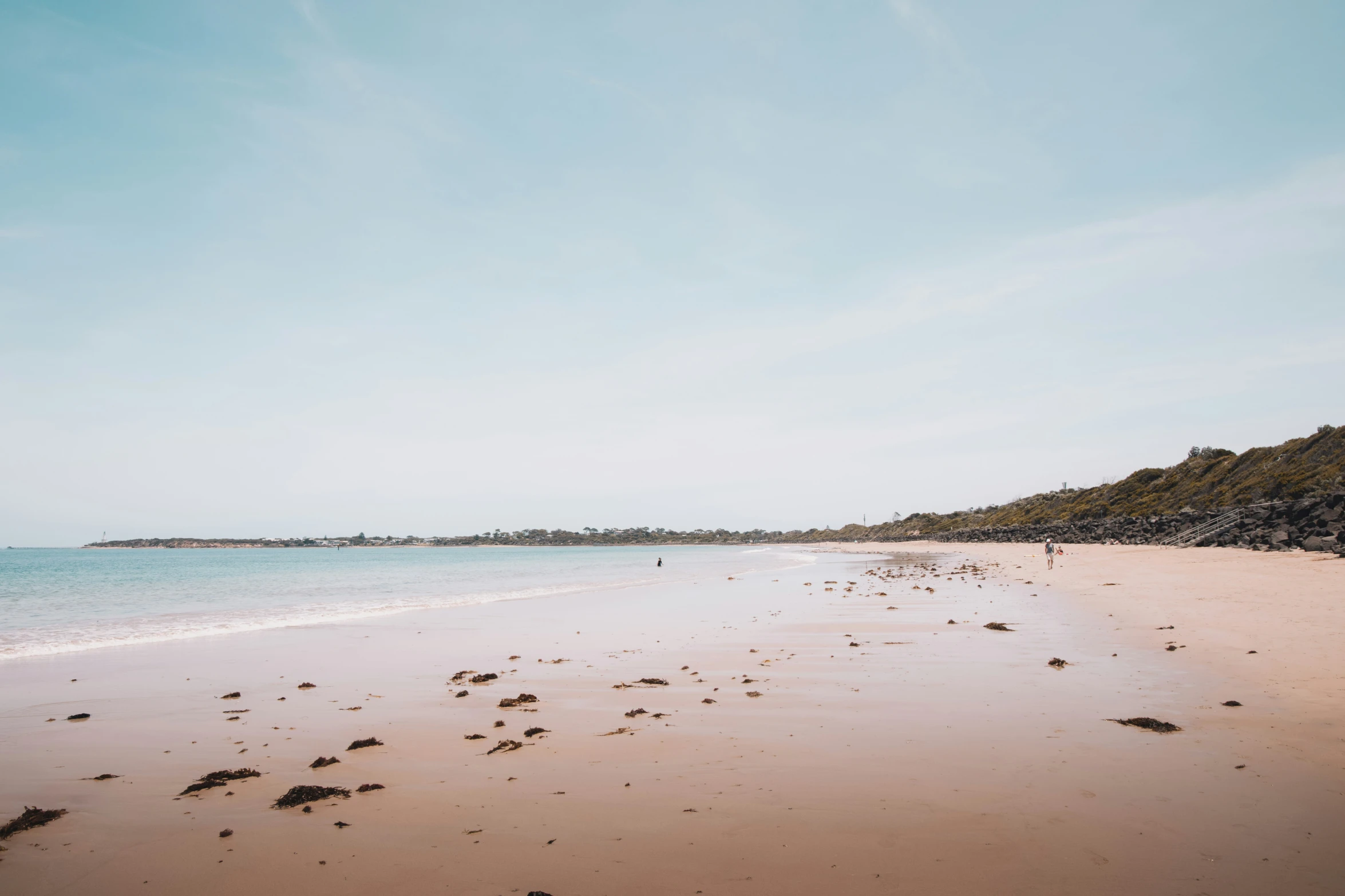 a beach area with an open expanse of sand and water