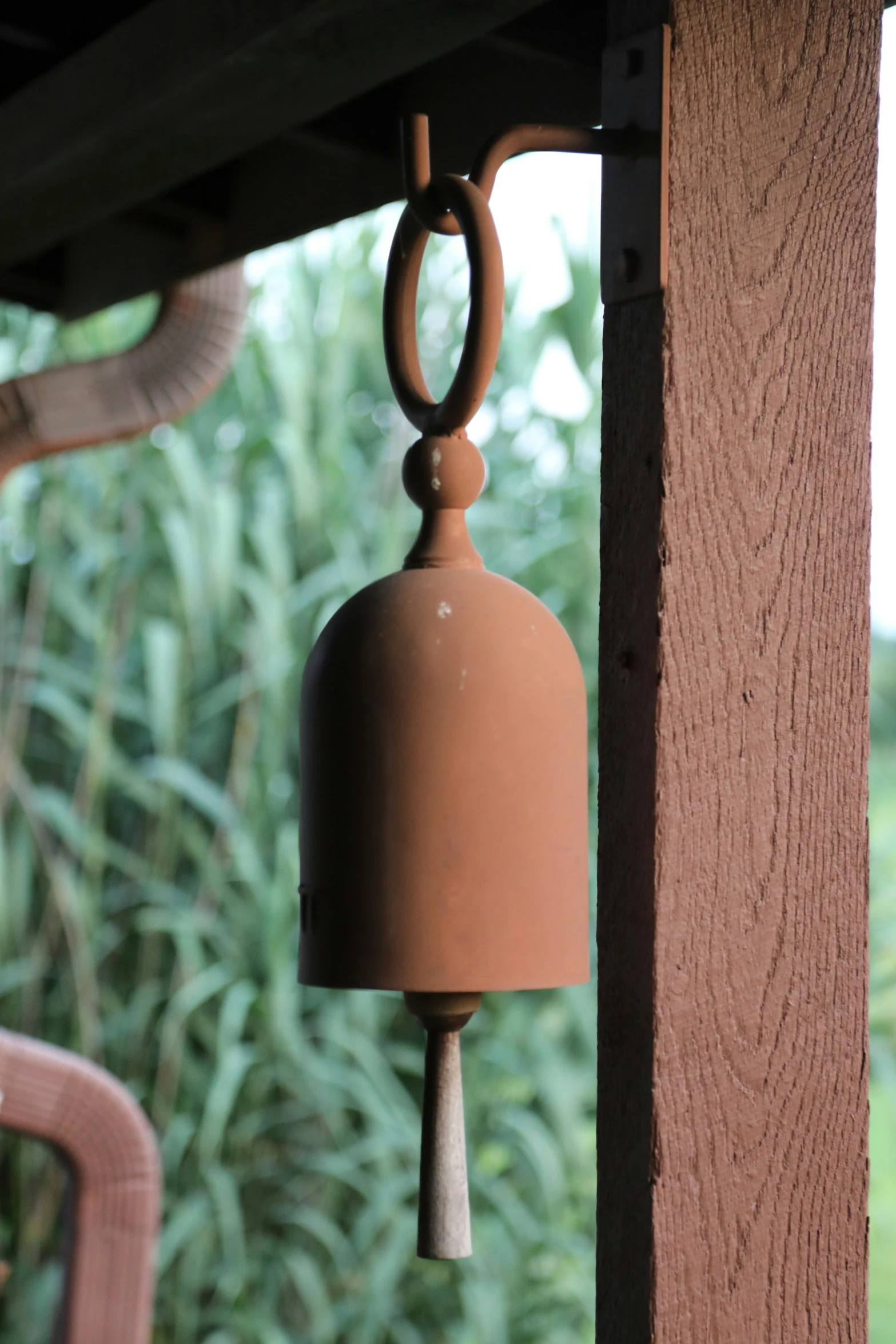 the large bell is on the side of the porch