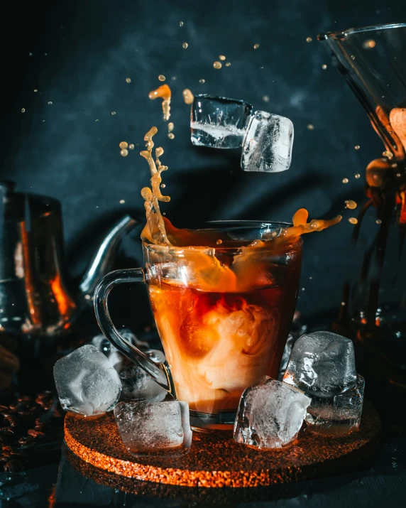 an ice bucket with a glass full of cola in it