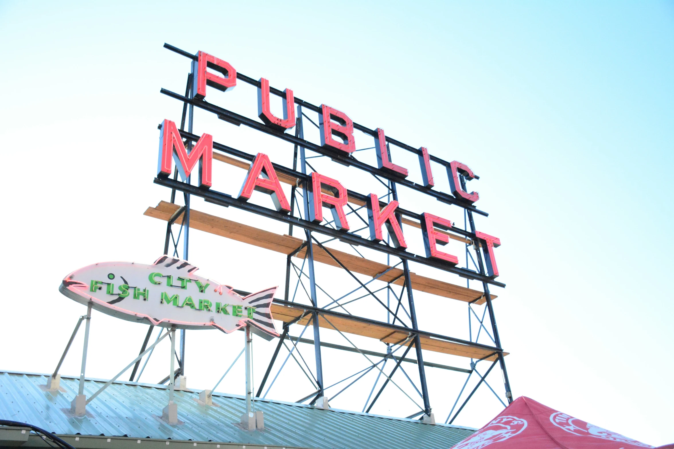 a sign is lit up above the city market