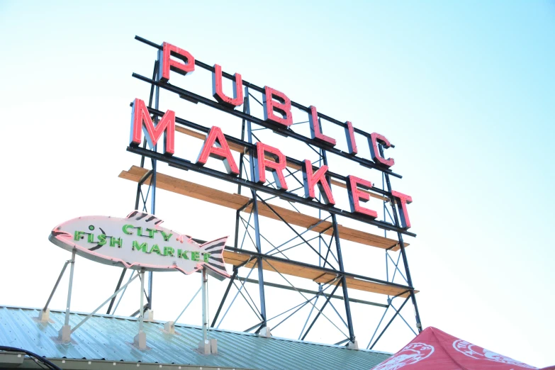 a sign is lit up above the city market