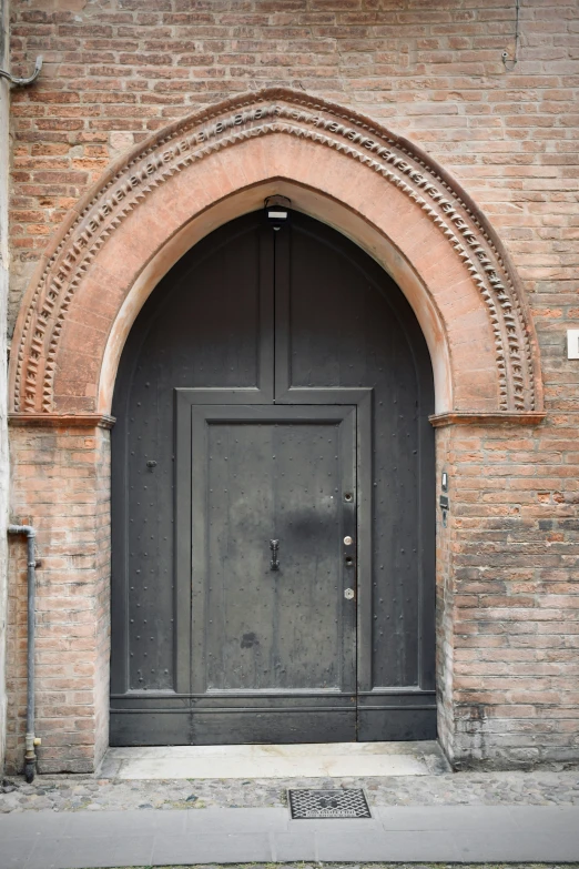 the entrance to a building with an ornate arch above it