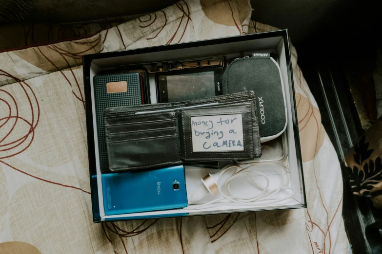 a black wallet with charger and cable inside of it