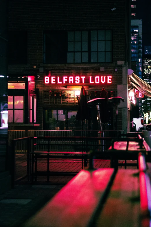 a bench outside in front of a building with a sign saying breakfast love