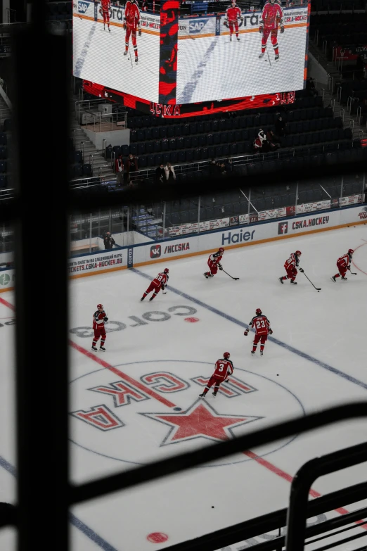 hockey players on the ice playing a game at an arena