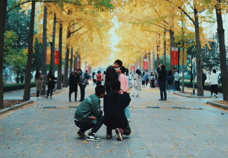 two people leaning over one another as they kneel down