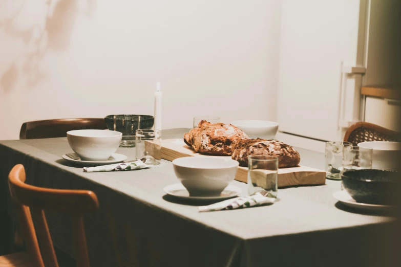 a table covered in food and glasses with a light shining on it