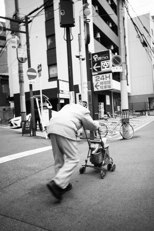 an older man hing a stroller through the street