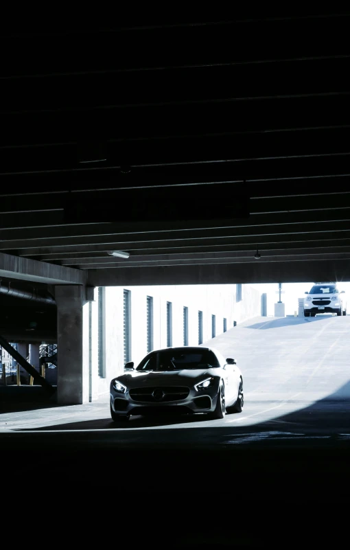 a car driving under an overpass at night